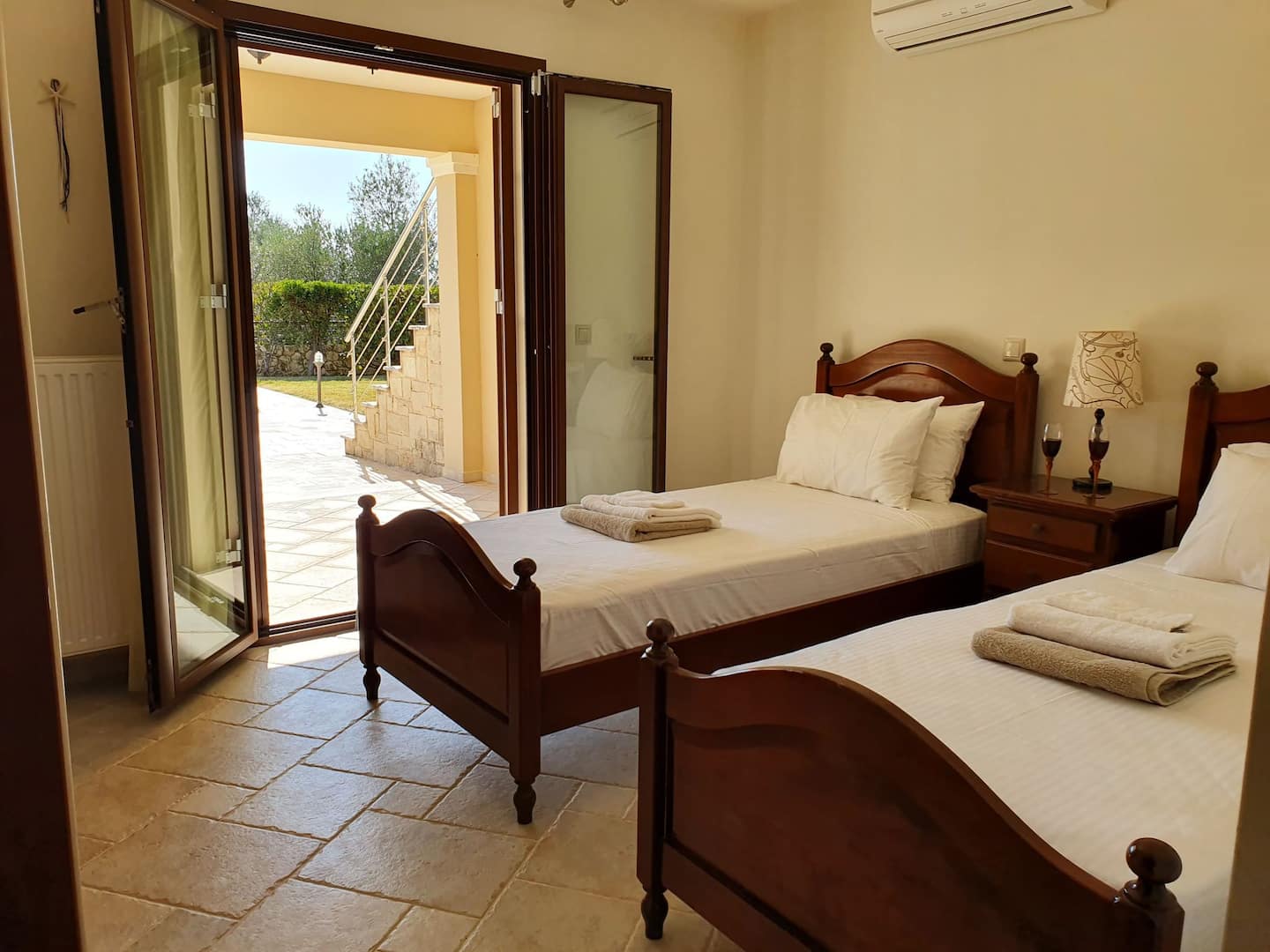 The second bedroom with two single beds and direct access to the pool